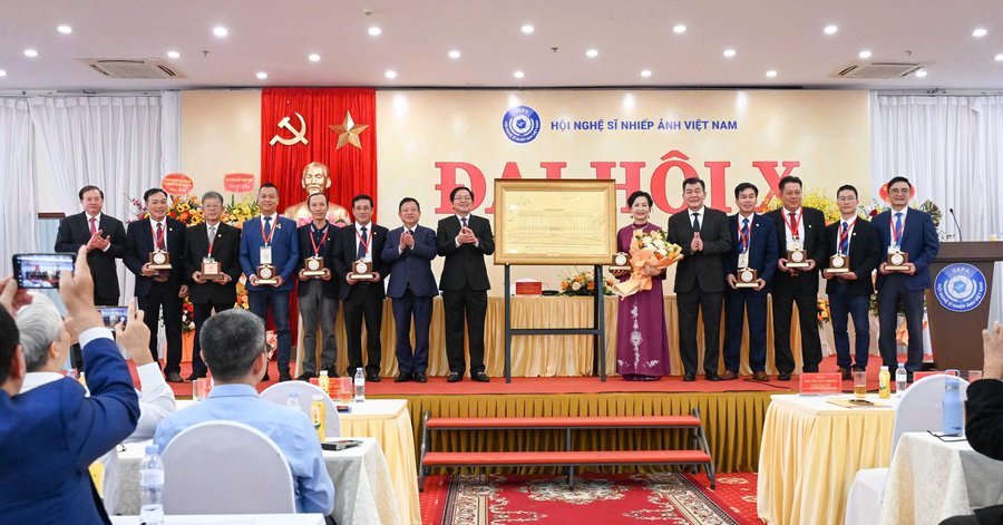 Phó Thủ tướng Chính phủ Hồ Quốc Dũng; Phó Chủ tịch Ủy ban Trung ương Mặt trận Tổ quốc Việt Nam Nguyễn Đức Phong; Thứ trưởng Bộ VHTTDL Tạ Quang Đông tặng hoa Ban Chấp hành Hội Nghệ sĩ Nhiếp ảnh Việt Nam khóa X